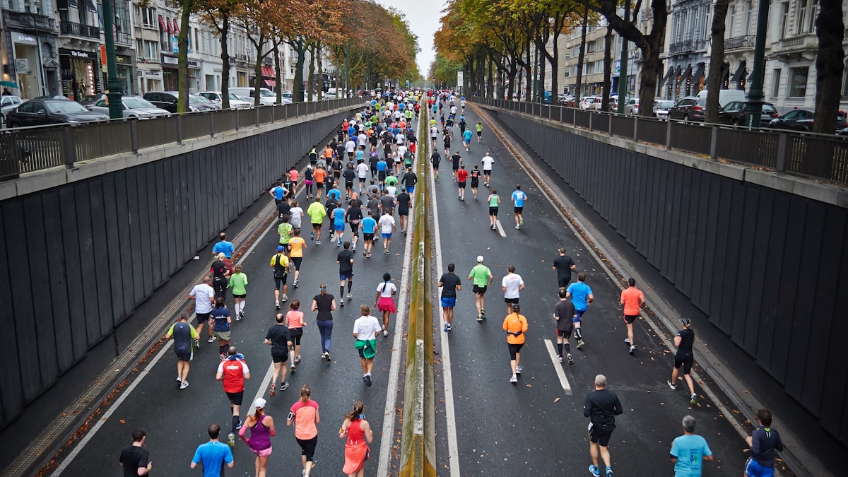 Runners competing in a road race on a coastal city street