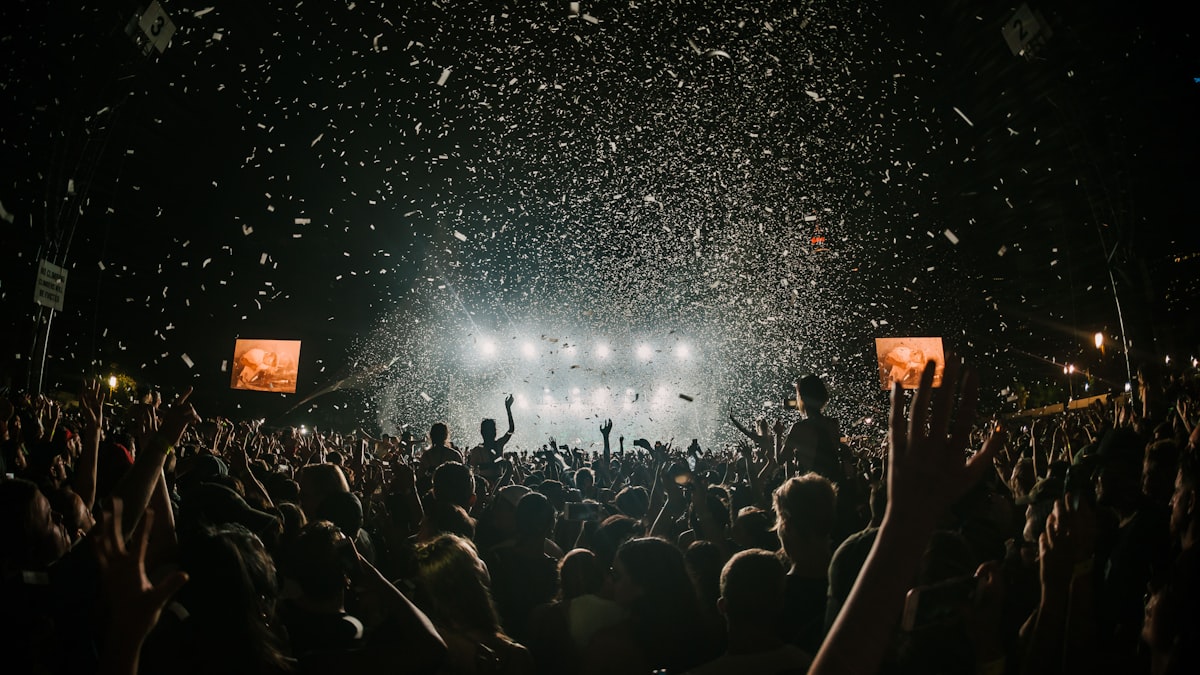 Outdoor summer festival with families and performers in a park setting